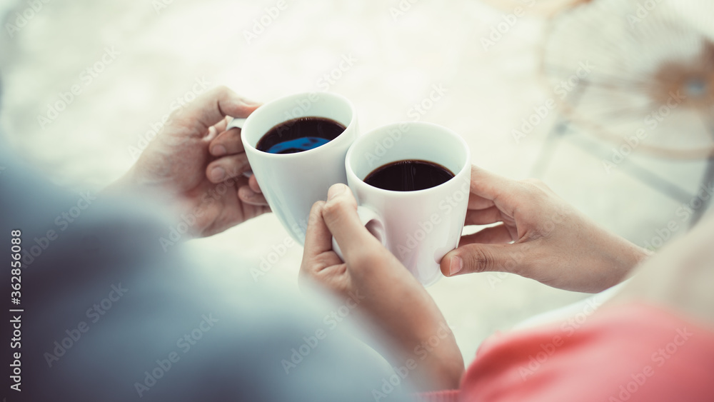 Close up of couple hands holding coffee