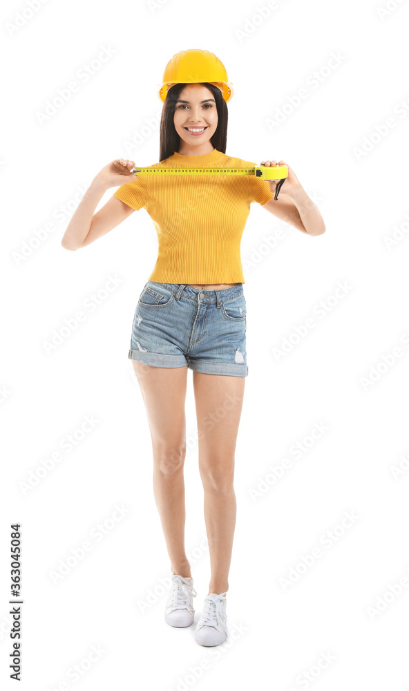 Young woman with measuring tape on white background