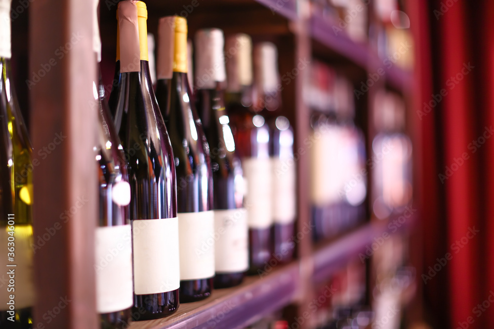 Rack with bottles of wine in store