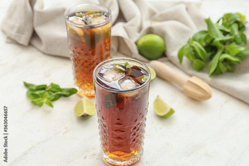 Glasses of tasty Cuba Libre cocktail on table