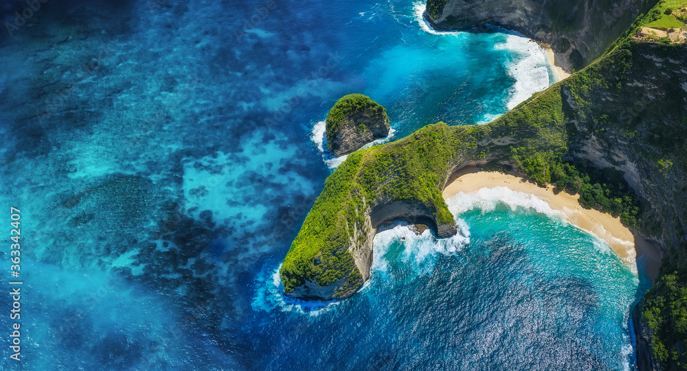 Panoramic aerial view at the sea and rocks. Blue water background from top view. Kelingking beach, N