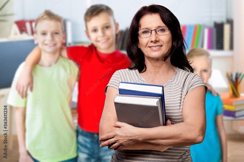 Smile woman teacher with books on student background