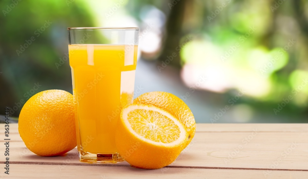 Orange juice and slices of orange on desk