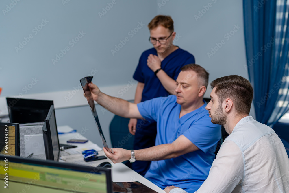 Doctor holding a picture of a brain MRI workflow in diagnostic hospital. Healthcare, roentgen, peopl