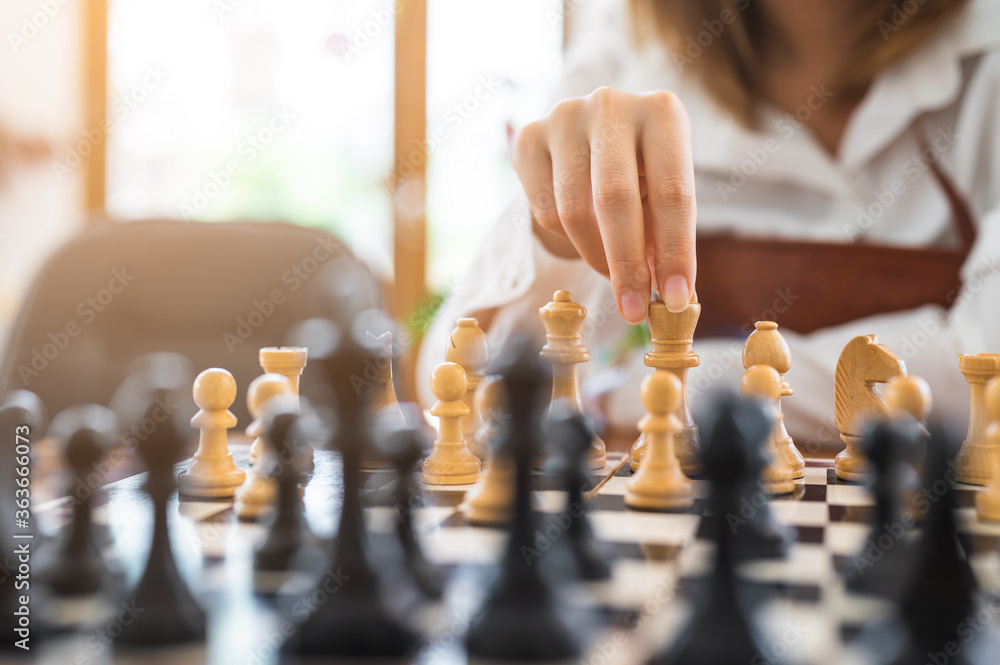 Woman playing chess in club. concept of competition and decision