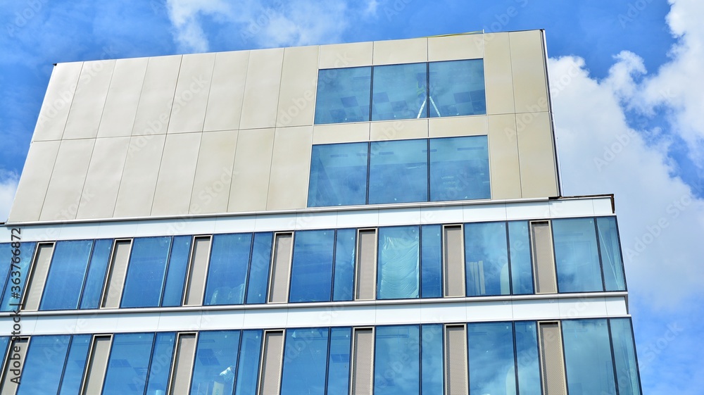 Facade texture of a glass mirrored office building. Fragment of the facade. Modern architecture of t