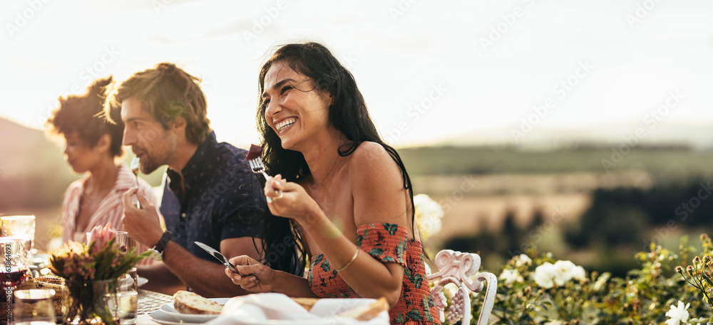 Woman having food with friends at a party