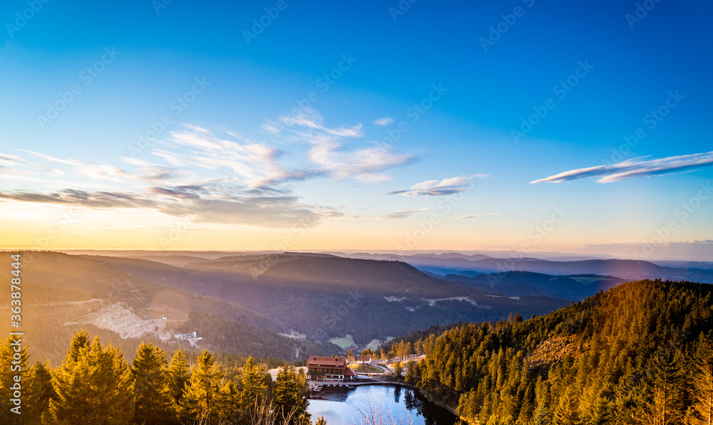 Bright Lake Mummelsee at sunrise, overlooking mountains landscape