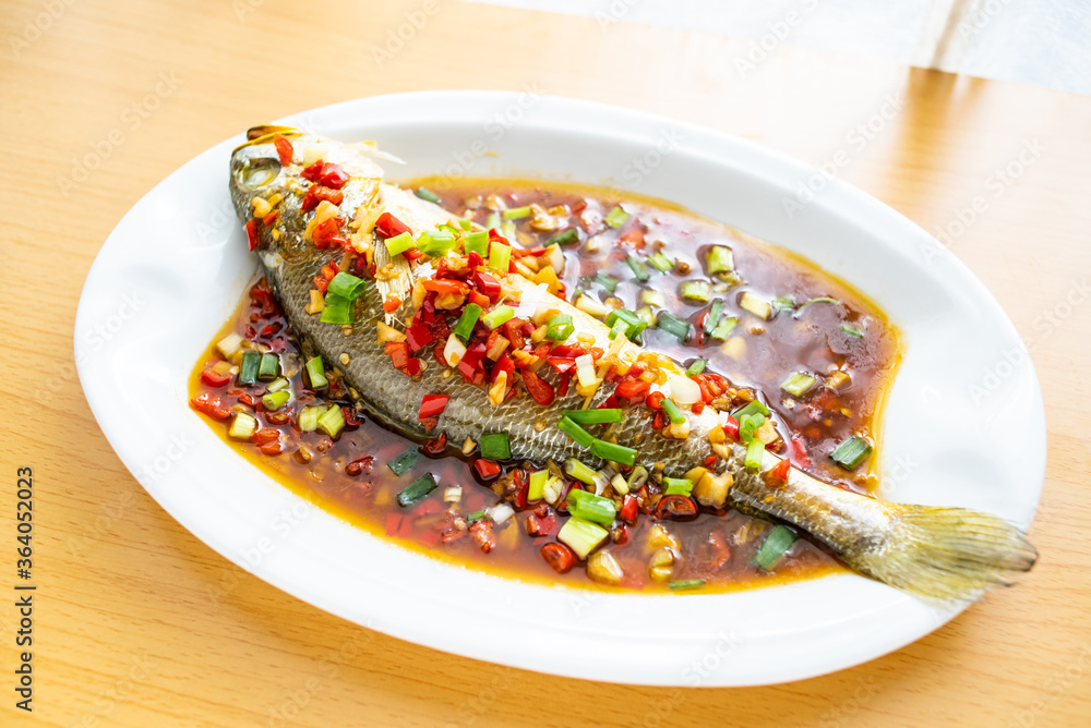 A dish of home-cooked braised croaker on the table