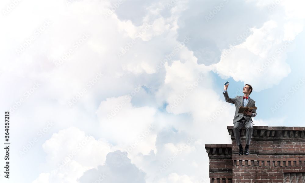 Young businessman or student studying the science on building roof