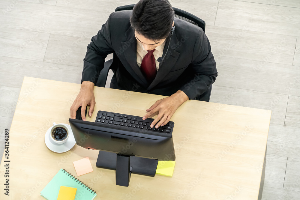 Business people wearing headset from top view in office working with computer to support remote cust