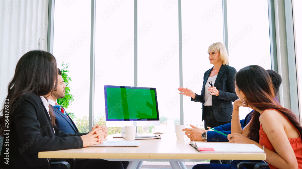 Business people in the conference room with green screen chroma key TV or computer on the office tab