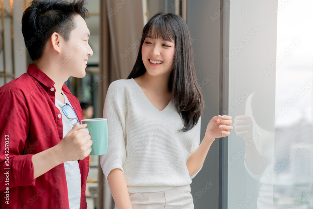 Happiness asian couple laugh smile together with in kitchen pantry humor emotional casual relax with