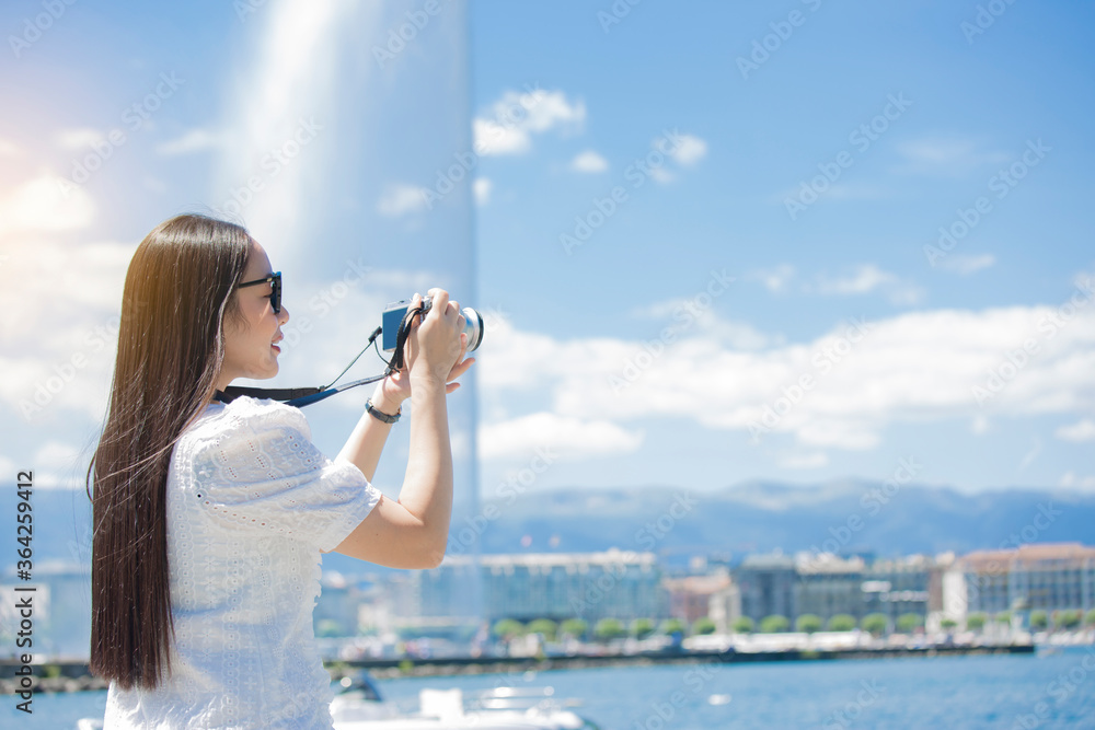 Asian beautiful woman is travel for holiday in the summer of Europe and taking a camera view landsca