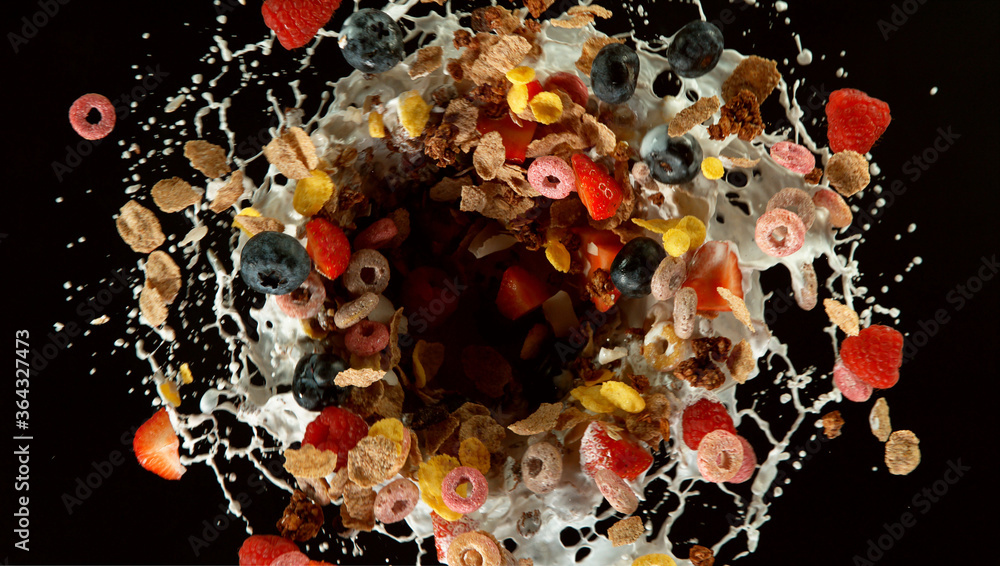 Freeze motion of rotating cereal pieces with milk splash