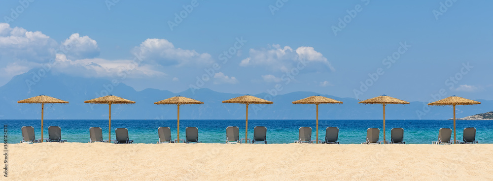 Beach chairs with umbrella with blue sky