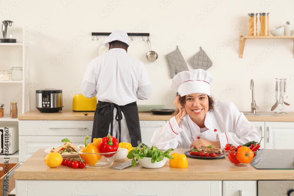 African-American chefs cooking in kitchen