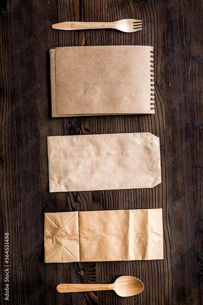 take away with flatware and paper bags on table background top view