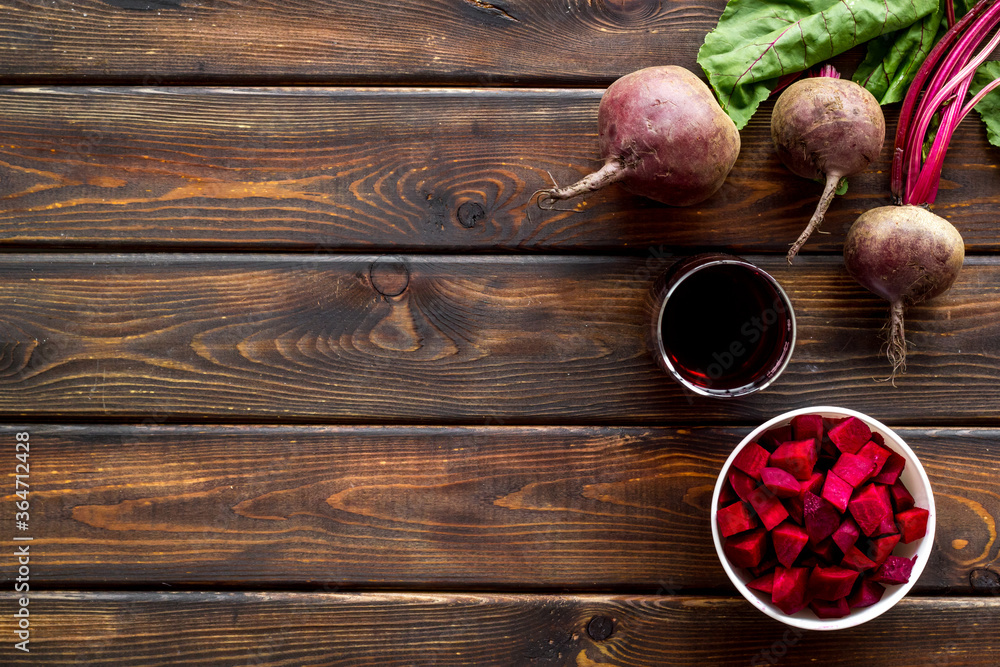 Sliced beet and juice on wooden table top view copy space