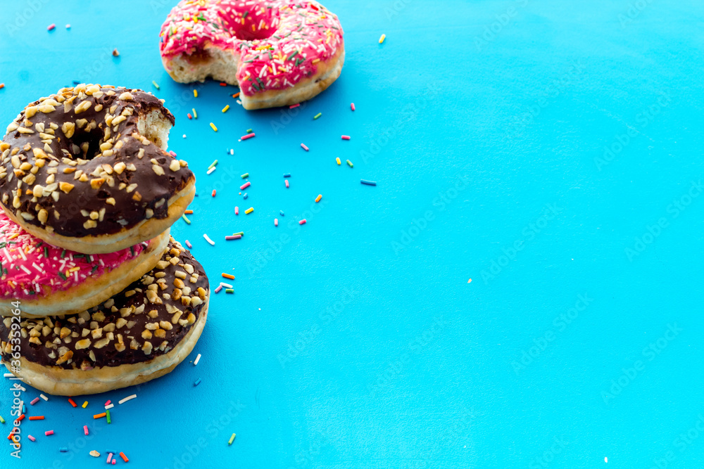 Colorful donuts close up, glazed and sprinkles bakery