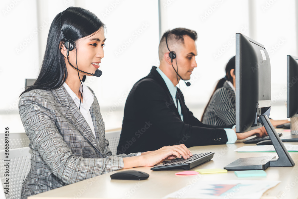 Business people wearing headset working in office to support remote customer or colleague. Call cent