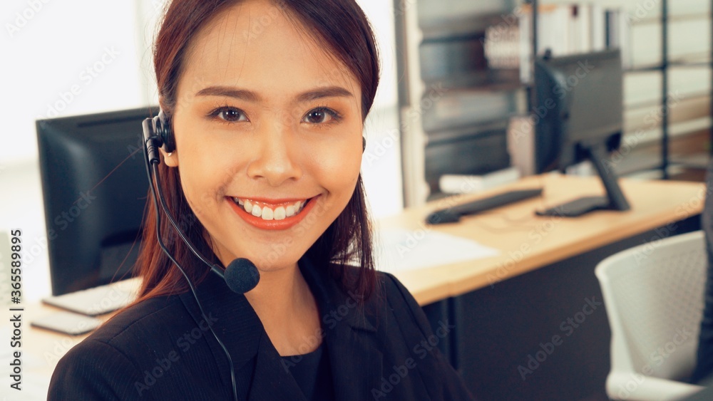 Business people wearing headset working in office to support remote customer or colleague. Call cent