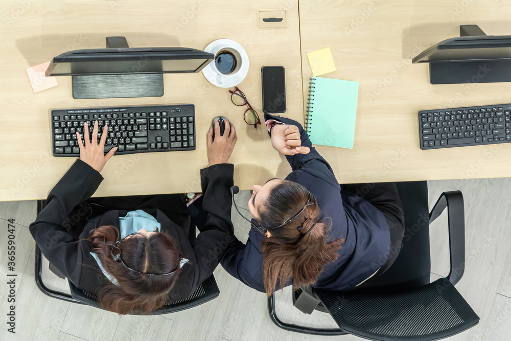 Business people wearing headset from top view in office working with computer to support remote cust