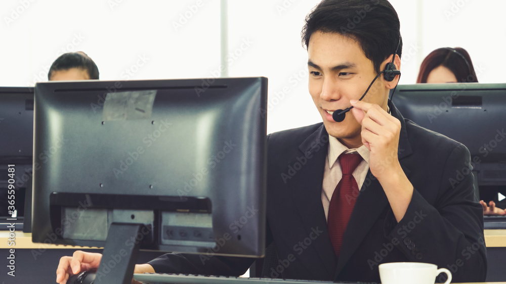 Business people wearing headset working in office to support remote customer or colleague. Call cent