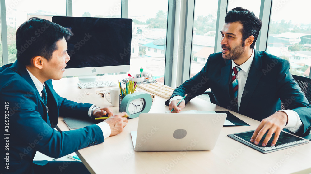 Two business people talk project strategy at office meeting room. Businessman discuss project planni