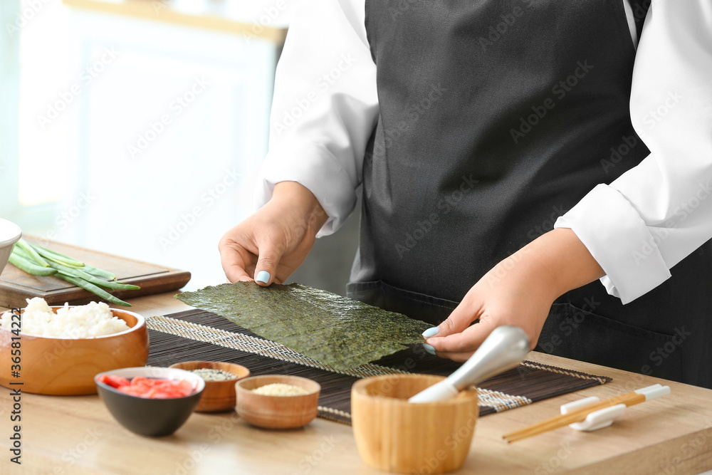 Beautiful Asian chef cooking in kitchen, closeup