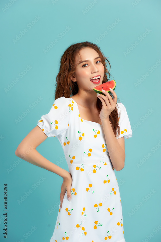 Tastes like summer. Joyful young woman holding slice of watermelon and smiling