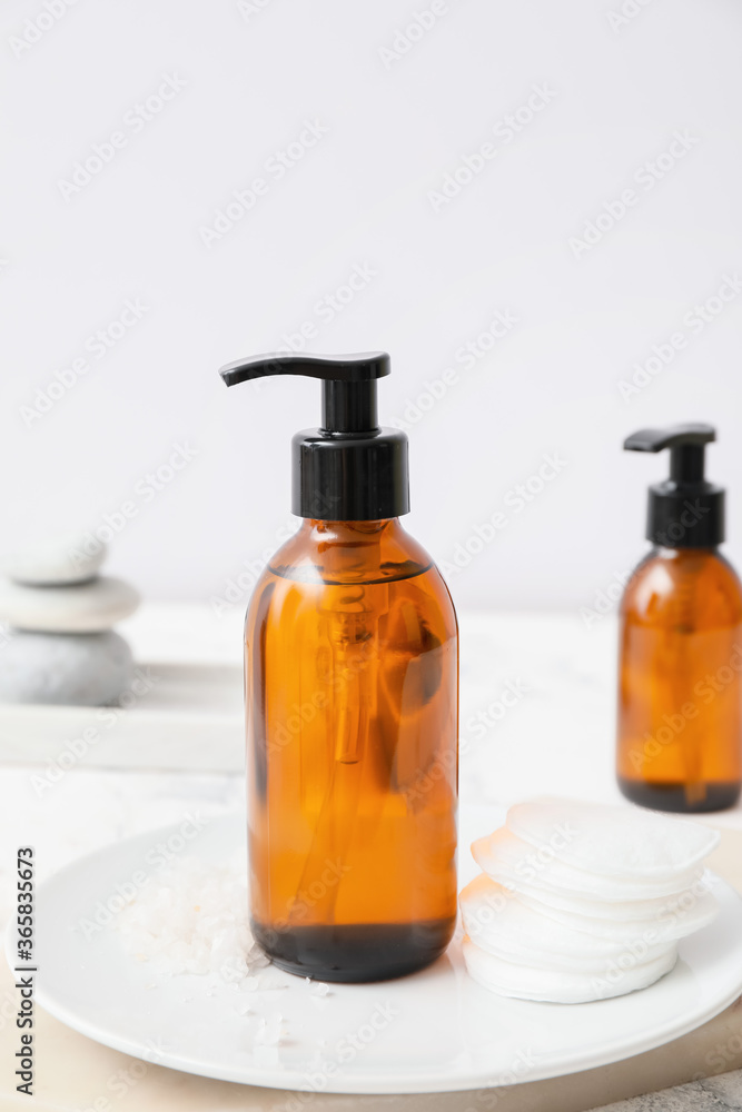 Bottles of different cosmetics on table