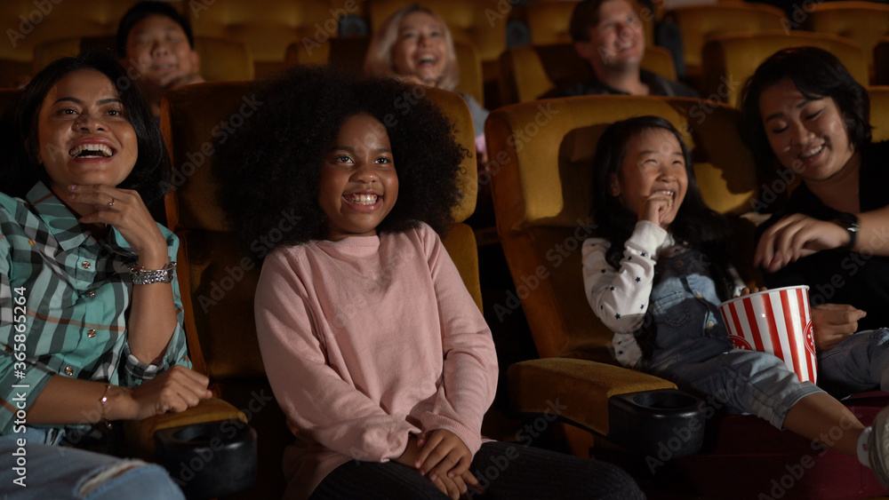 People audience watching movie in the movie theater cinema. Group recreation activity and entertainm