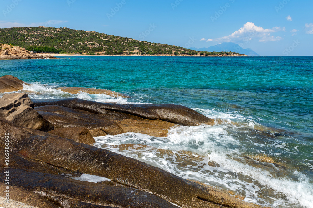 Landscape with sea, the rock and the beautiful clouds in the blue sky