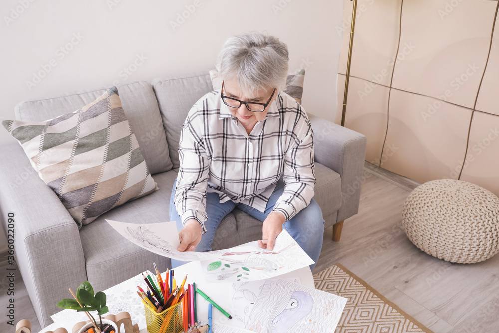 Senior woman coloring picture at home