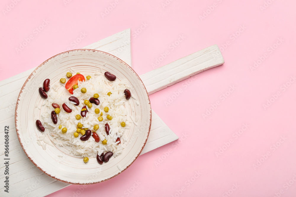 Plate with tasty rice and beans on color background