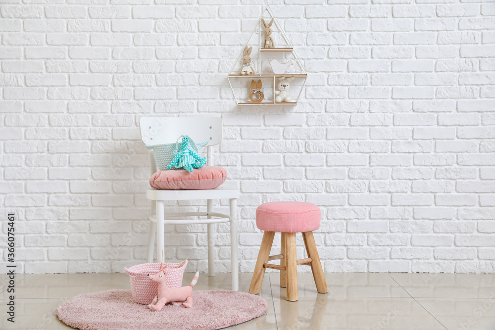 Chair with baskets and kid toys in room