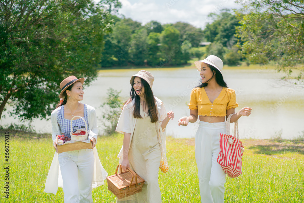 Asian girl friends group they are going to picnic. at the park