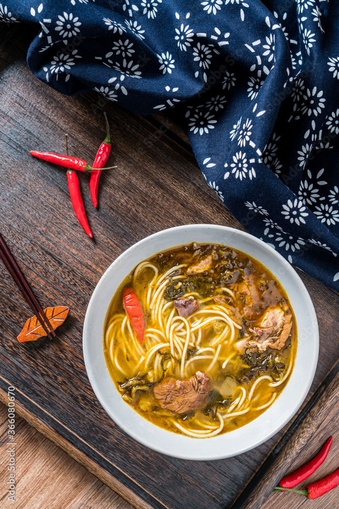 Beef noodles with sauerkraut in old altar on wooden table