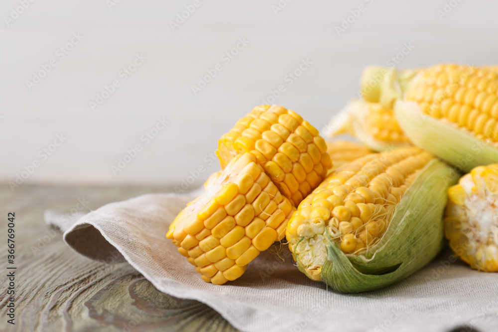 Fresh corn cobs on table