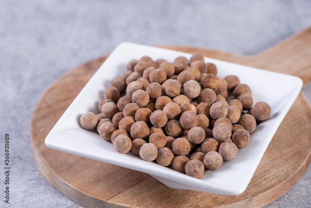 Dry raw brown tapioca pearls isolated on gray cement concrete background, close up, ingredient of ma