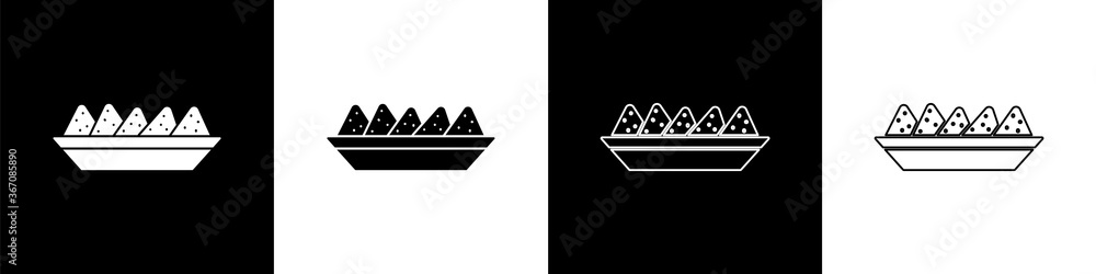将墨西哥玉米片放在黑白背景上隔离的盘子图标中。墨西哥玉米片或墨西哥玉米饼。