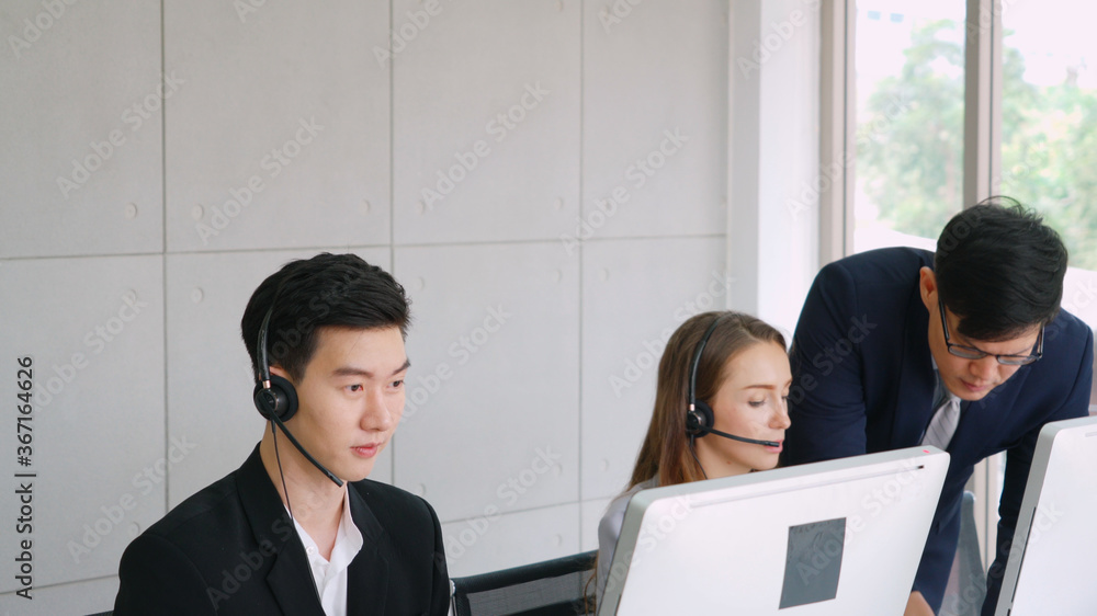 Business people wearing headset working in office to support remote customer or colleague. Call cent