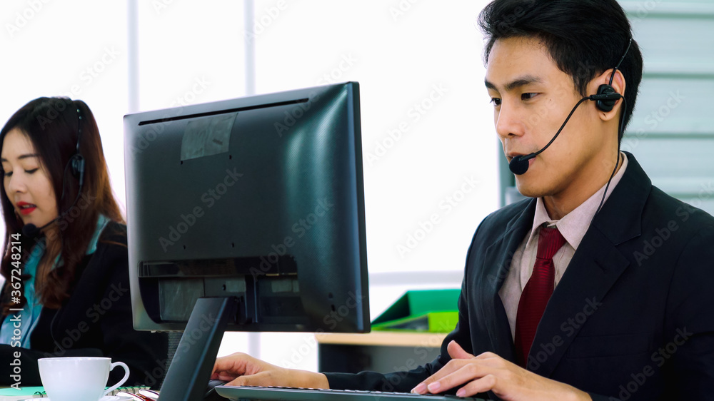 Business people wearing headset working in office to support remote customer or colleague. Call cent