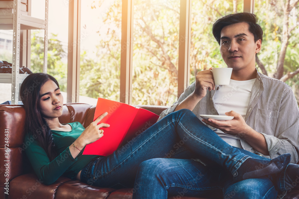 Happy Asian couple drink coffee at home. Love relationship and lifestyle concept.