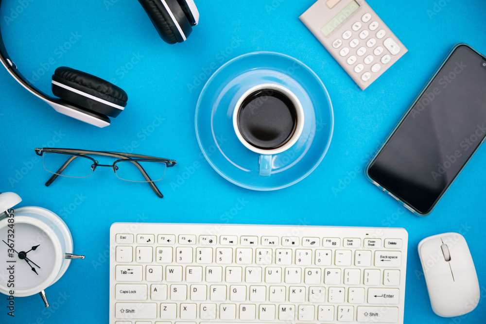 Office desk table of Business workplace and business objects on blue background.