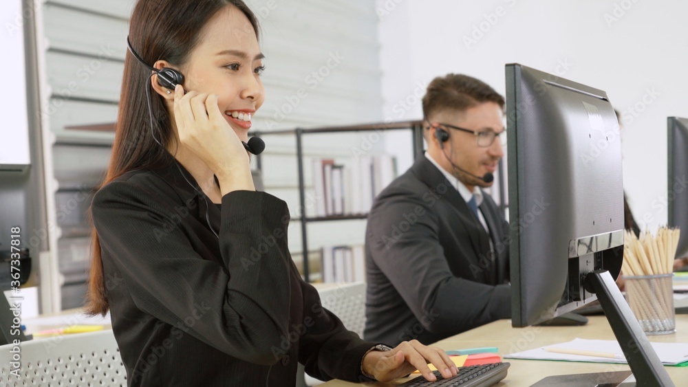 Business people wearing headset working in office to support remote customer or colleague. Call cent