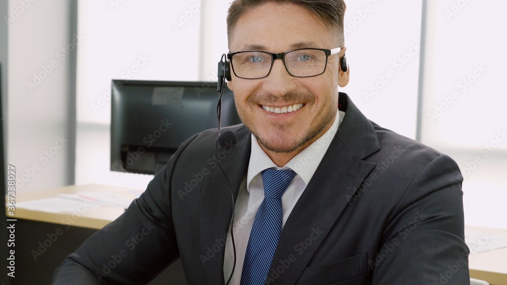 Business people wearing headset working in office to support remote customer or colleague. Call cent