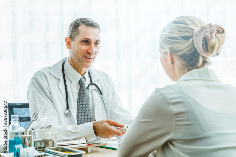 Doctor in professional uniform examining patient at hospital or medical clinic. Health care , medica