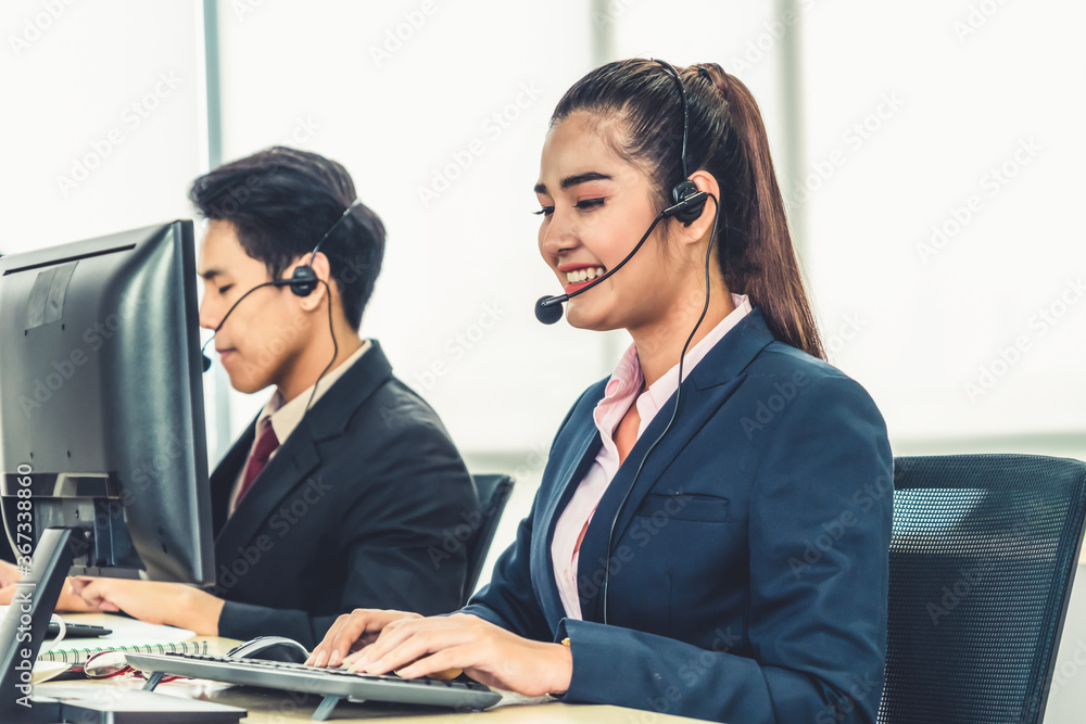 Business people wearing headset working in office to support remote customer or colleague. Call cent